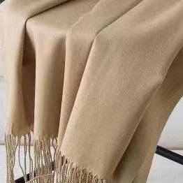 Beige scarf with fringe on a white background