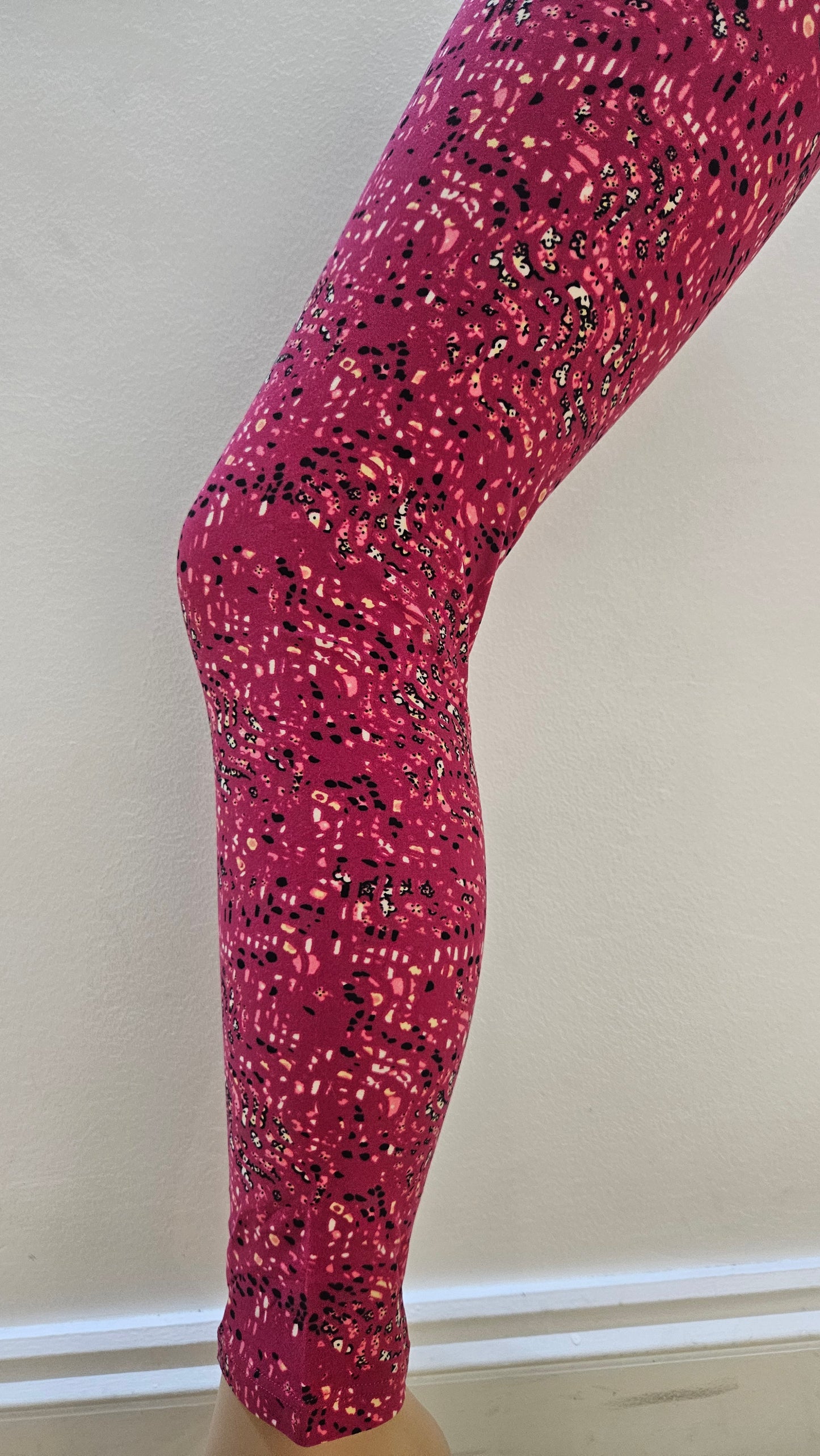 Pink tights with black speckles on a white background