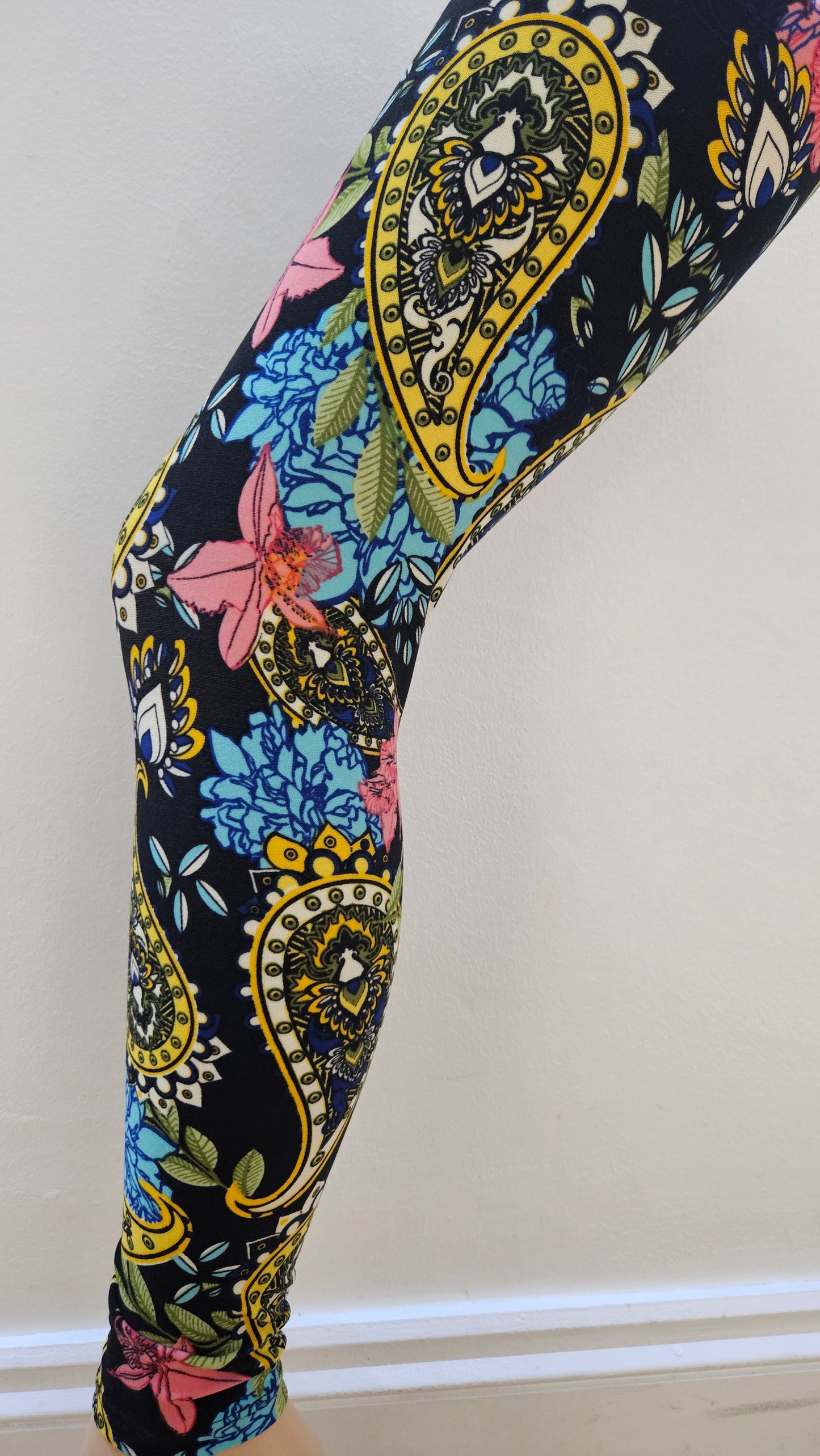 Multicolored patterned leggings on a white background