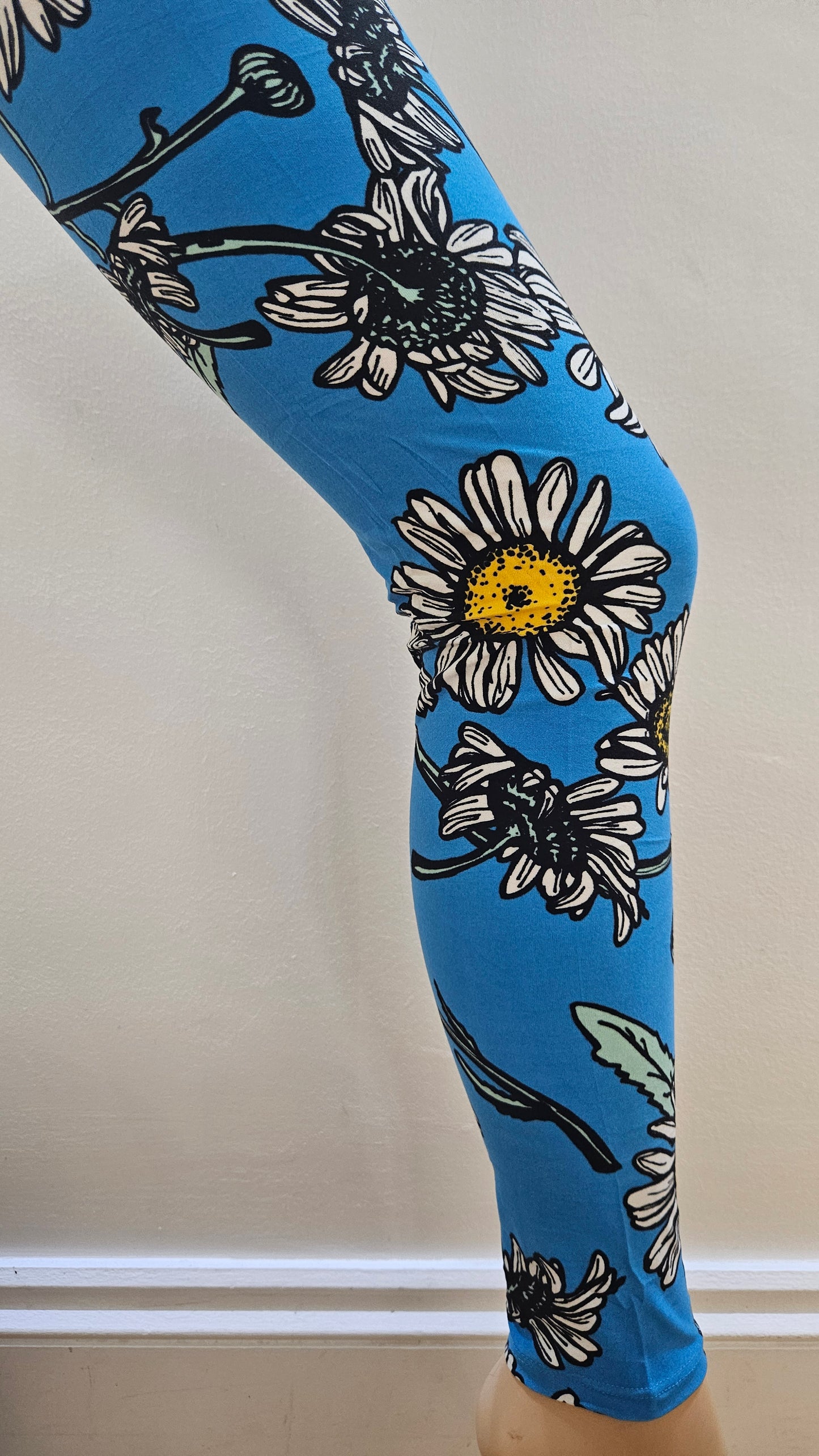 Blue leggings with floral pattern on a white surface