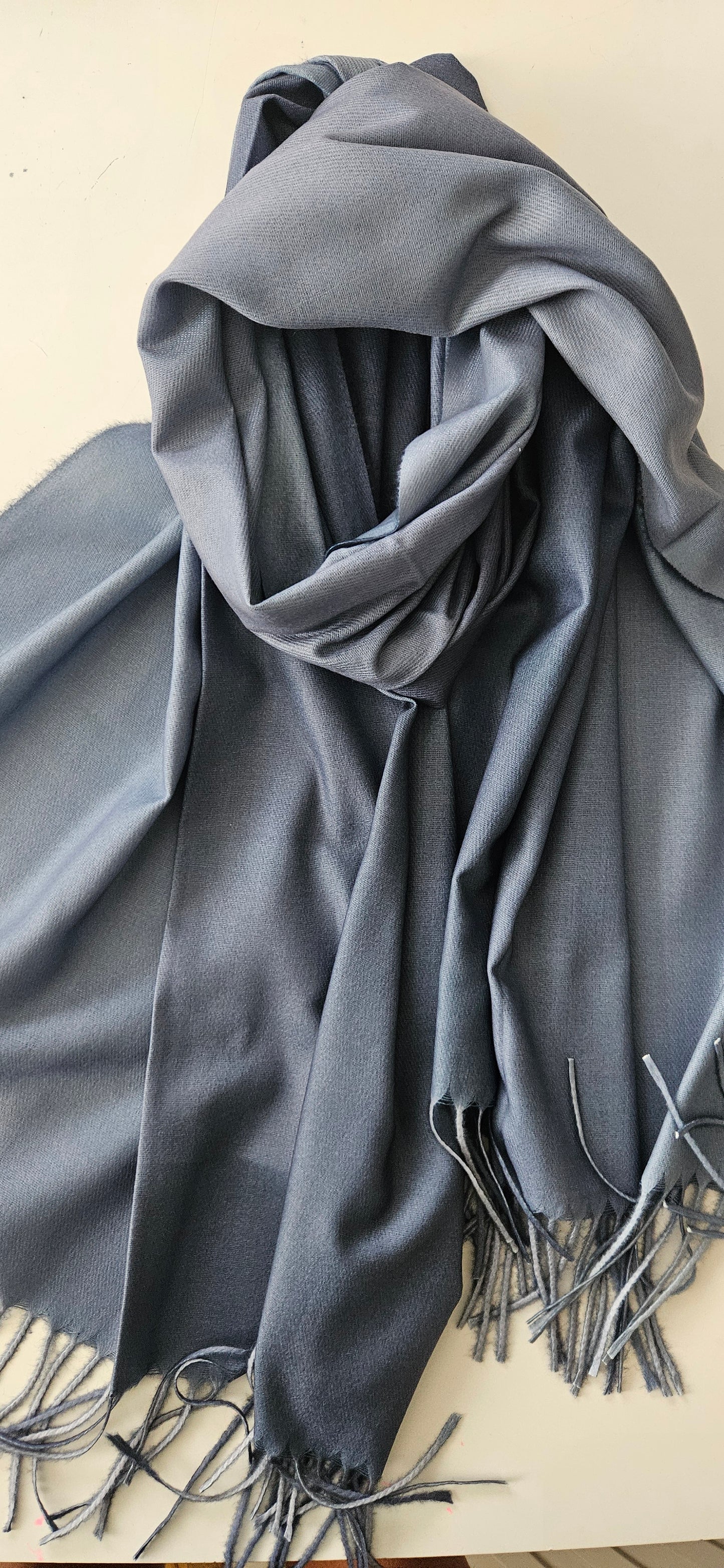 Blue Two Toned scarf with tassels on a white background