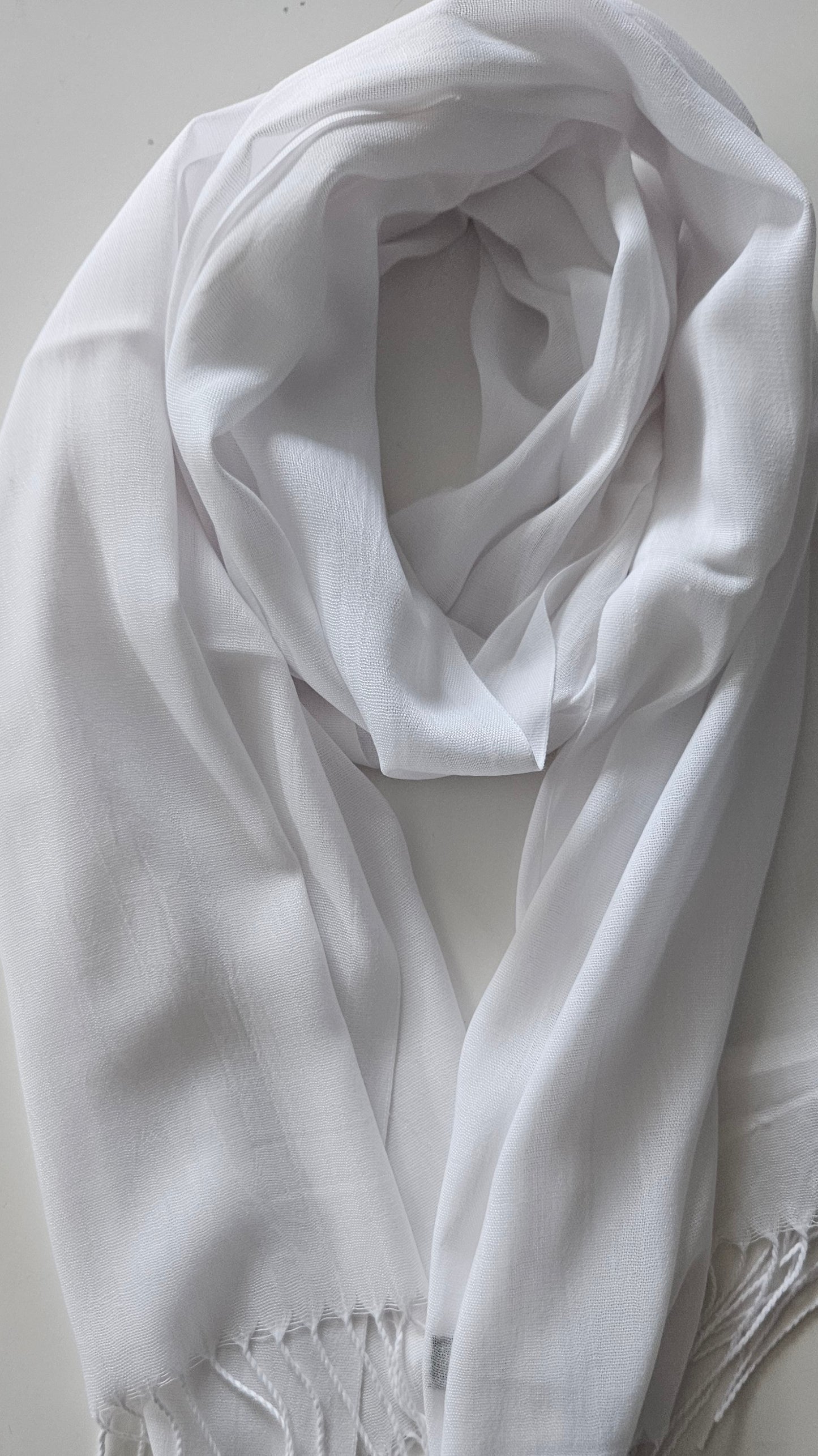 White scarf draped over a white surface