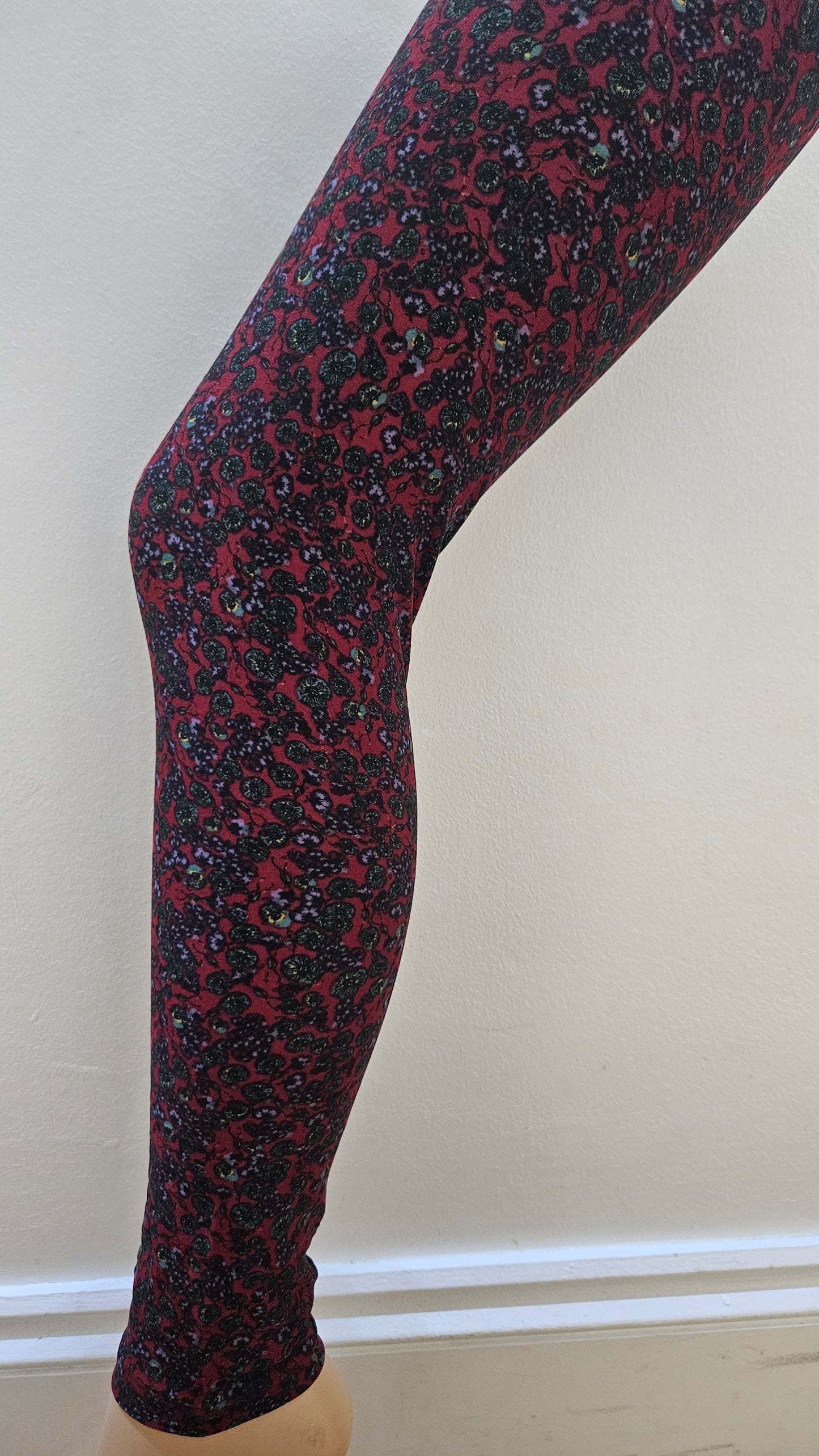 Red and black patterned tights on a white background