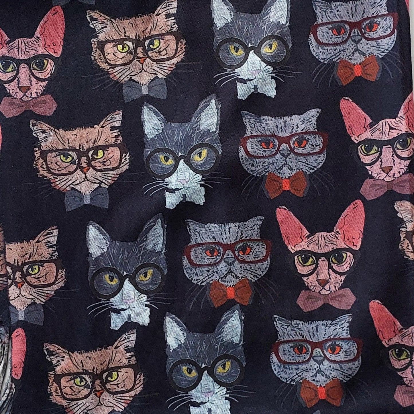 Pattern of cats wearing glasses and bow ties on a black background