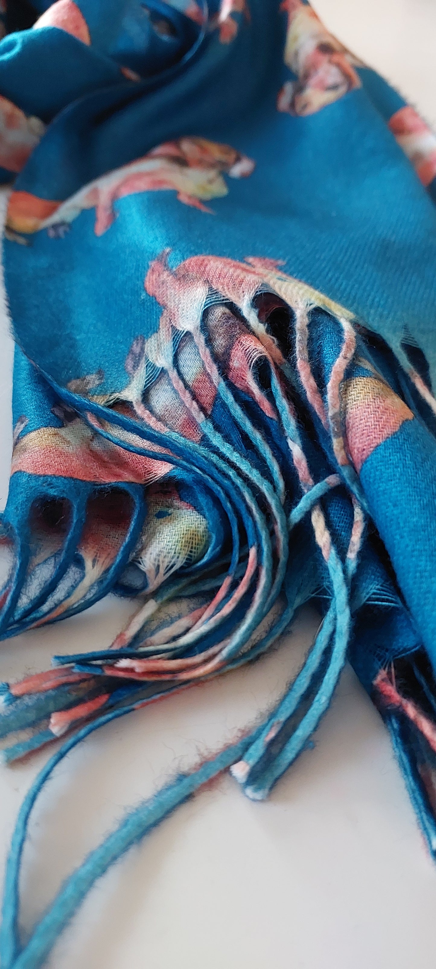 Colourful scarf tassels with sausage dog patterns on a white background