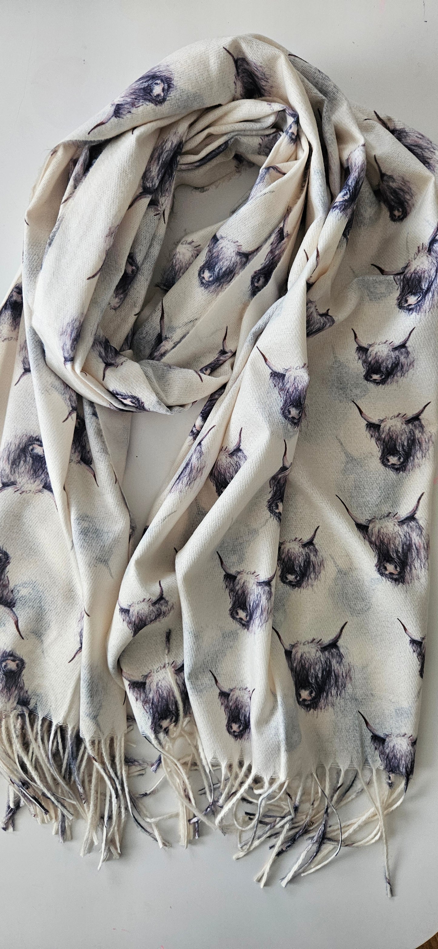 Cream Scarf with highland cow pattern on a white background