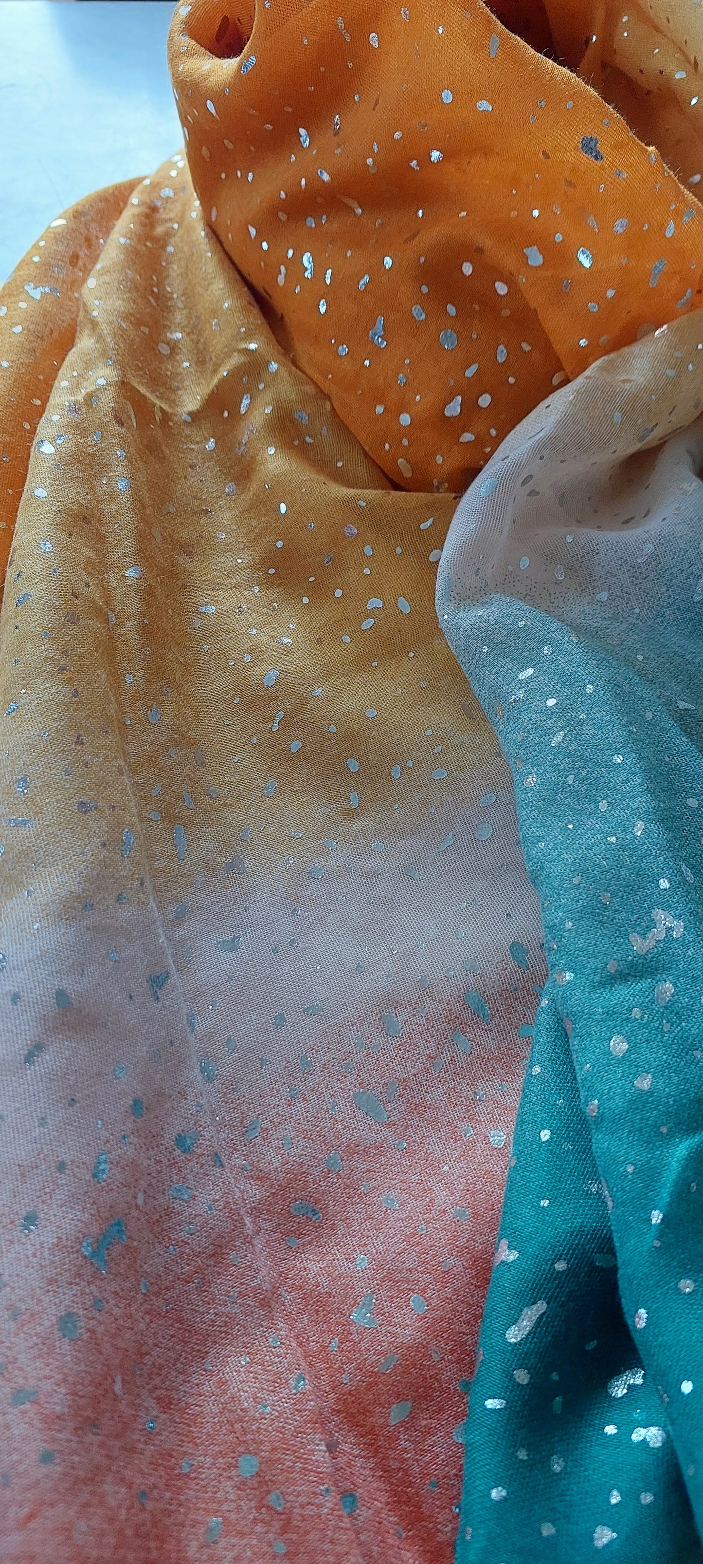 Close-up of colorful scarf with metallic splash pattern