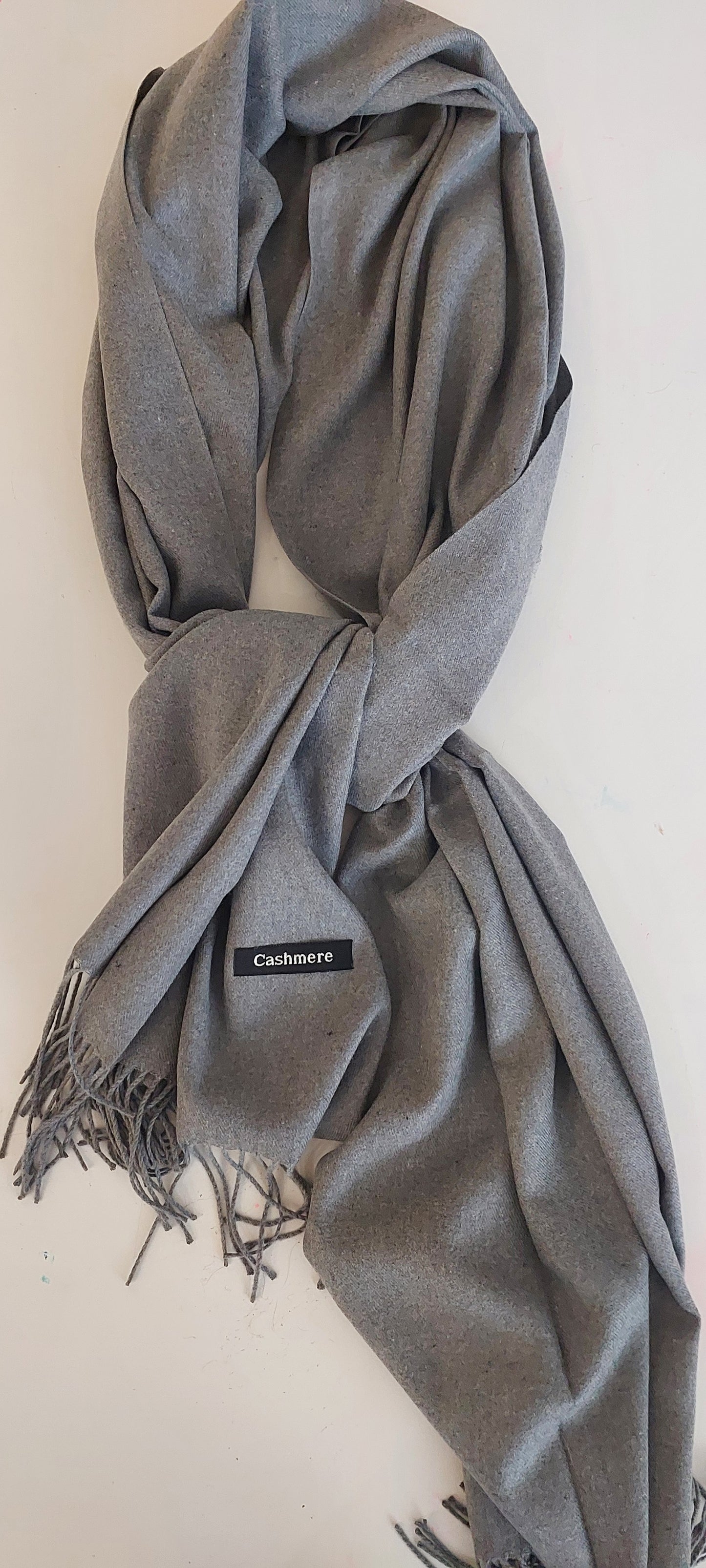 Grey scarf with a cashmere logo on a white background
