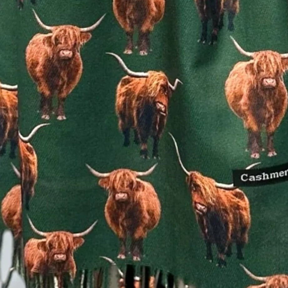 Bottle Green scarf fabric, with tassels showing at the bottom, with full coloured Highland Cows printed all over it