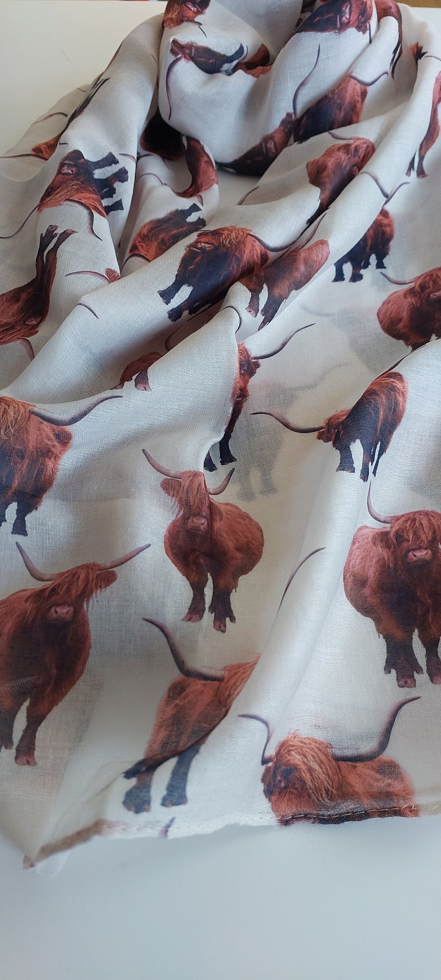 Cream Scarf with highland cow print on a white background