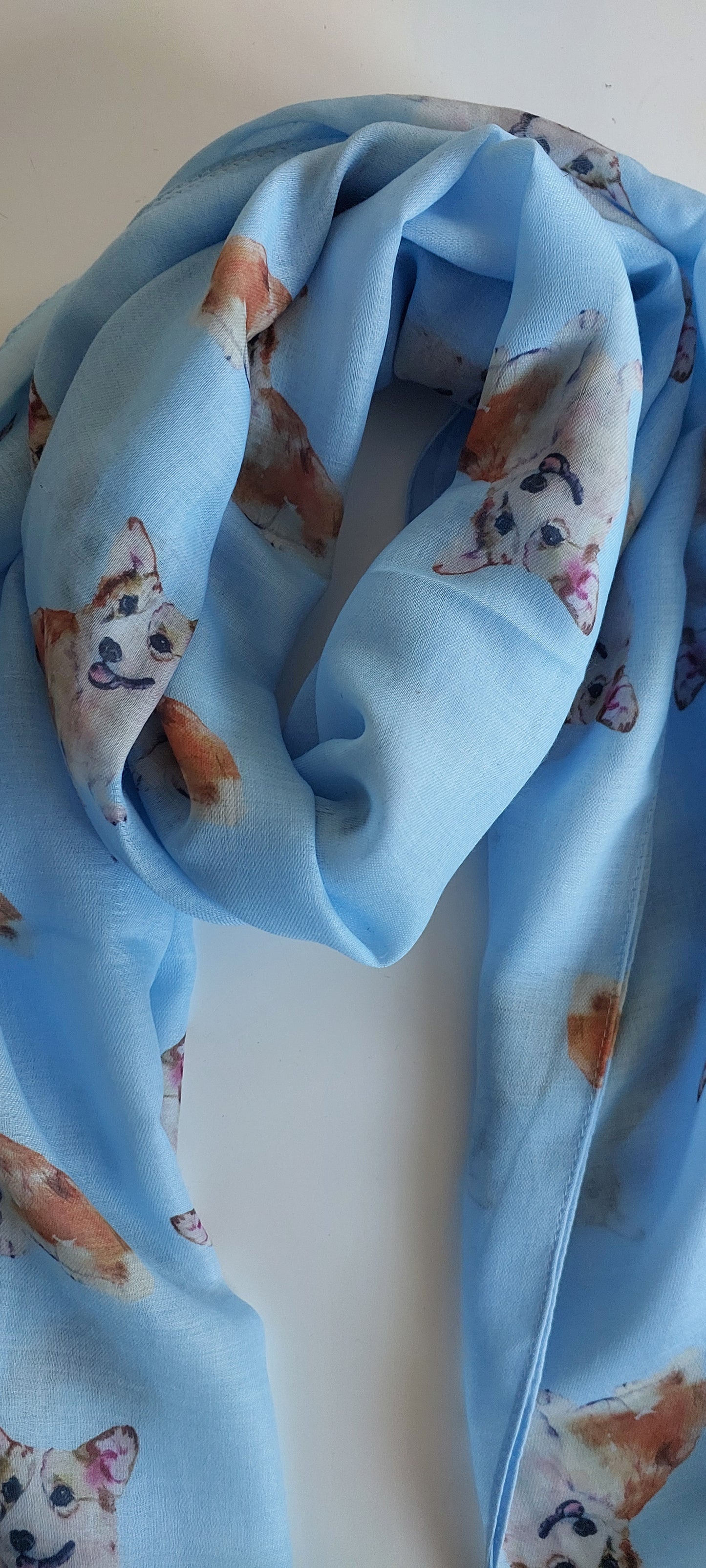 Blue scarf with corgi pattern on a white background