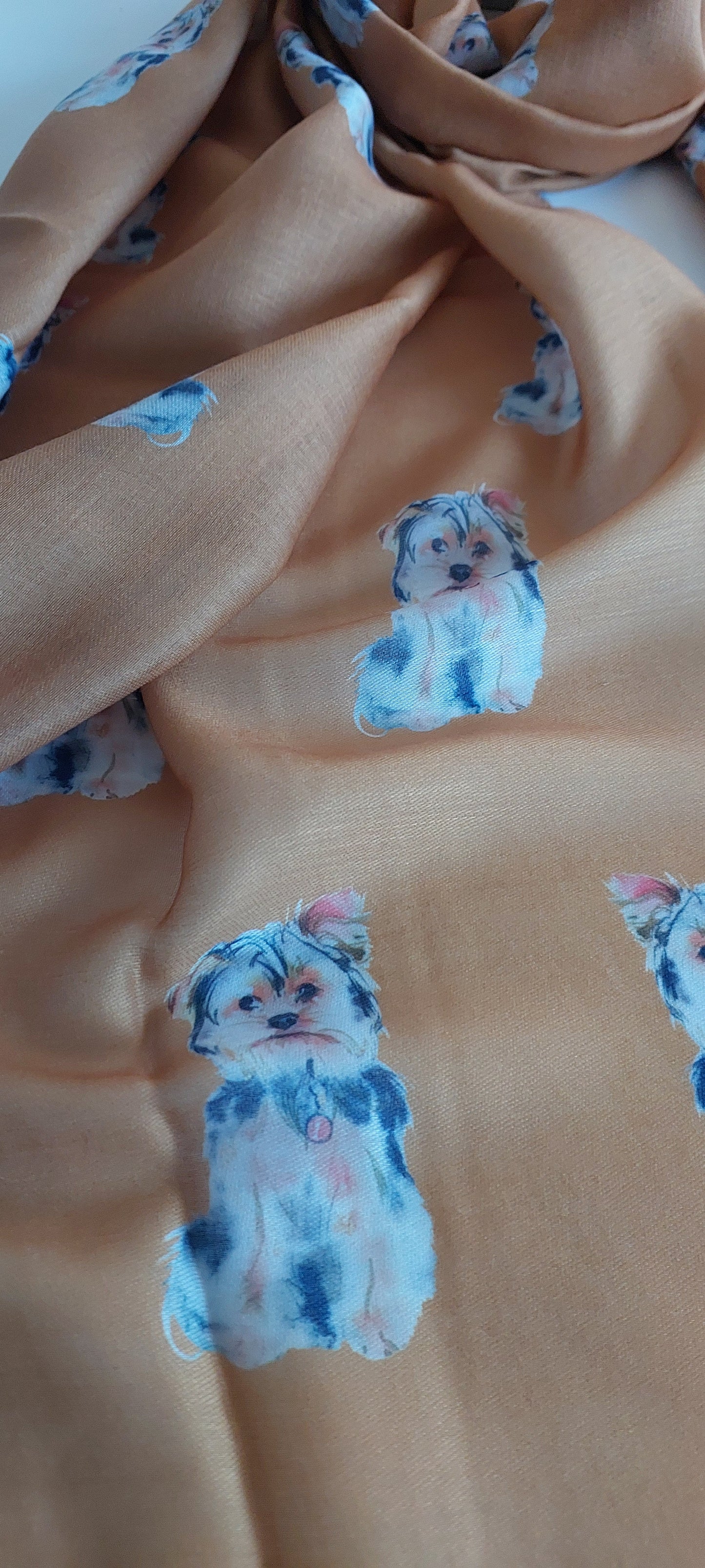 Close-up of mustard scarf with Yorky dog pattern on