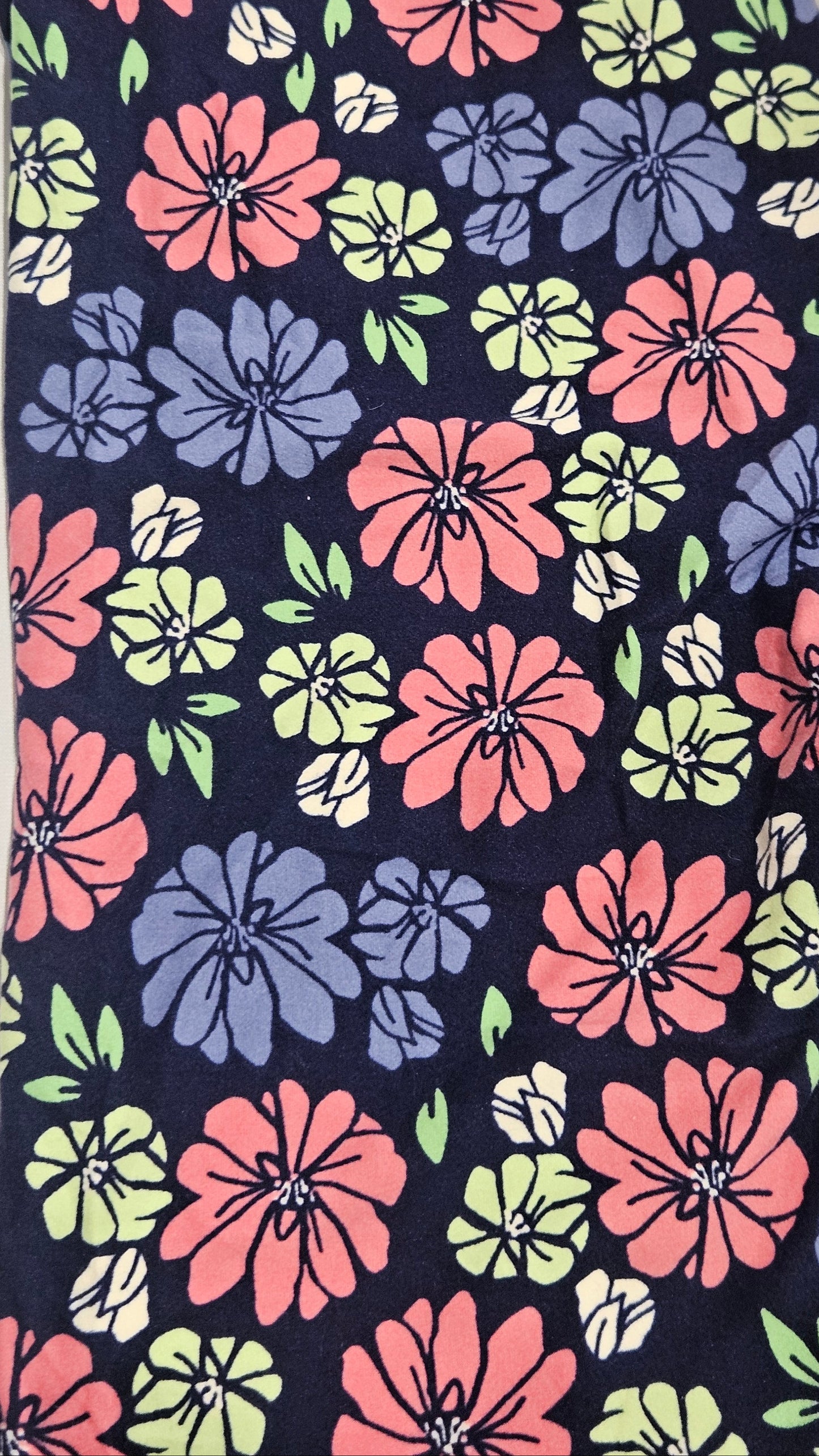 Floral patterned fabric with pink, blue, and green flowers on a dark background