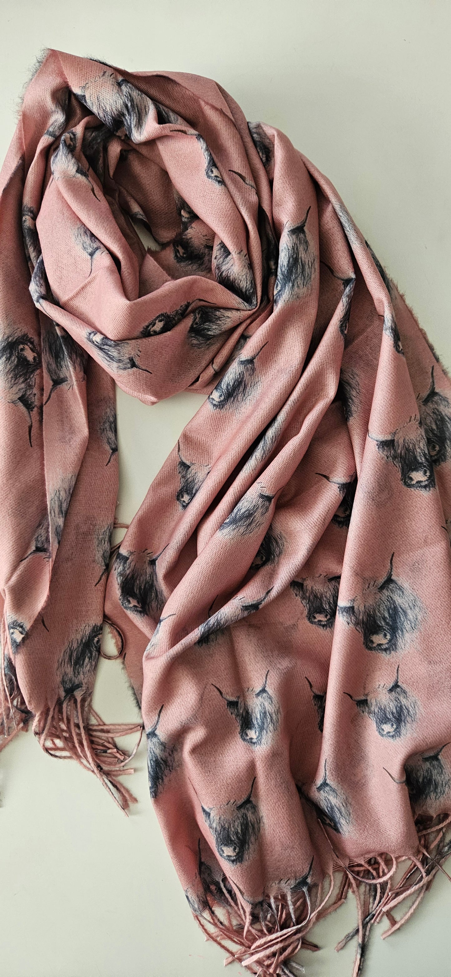 Pink scarf with black & white highland cow on a white background
