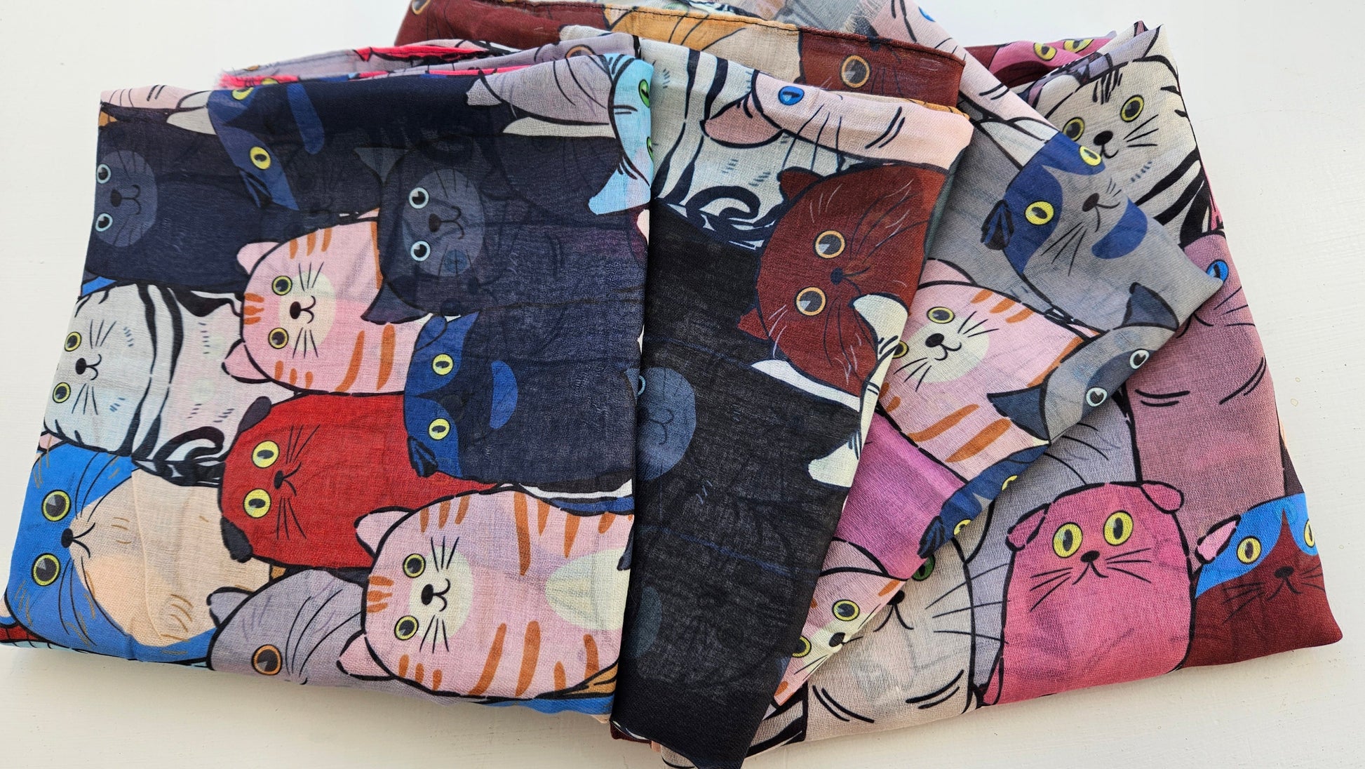 Array of Cat Scarves laid on white background