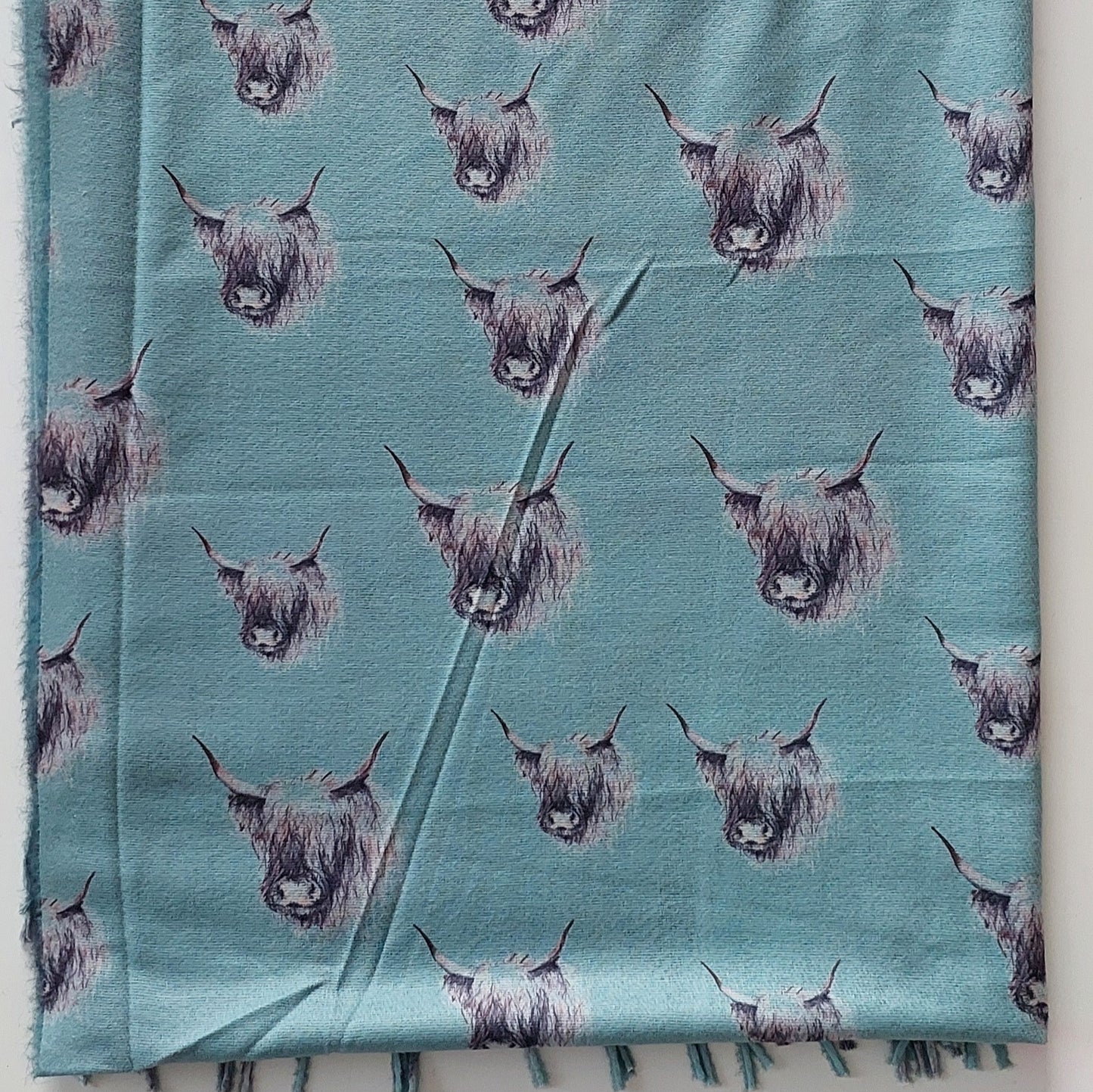 Pashmina with highland cow pattern on a white background