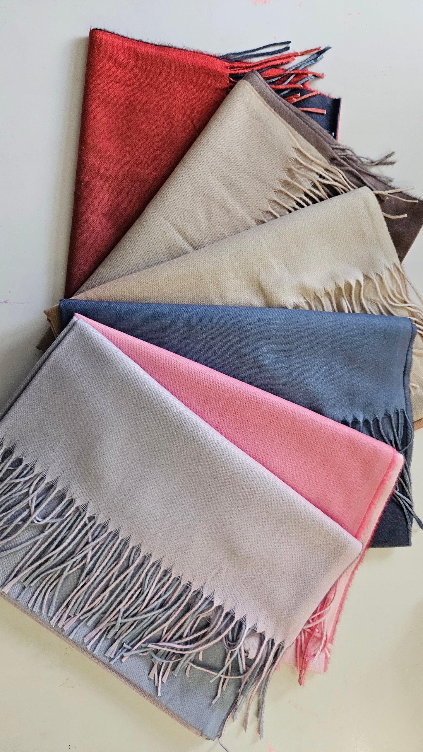 Selection of two toned pashminas on a white background
