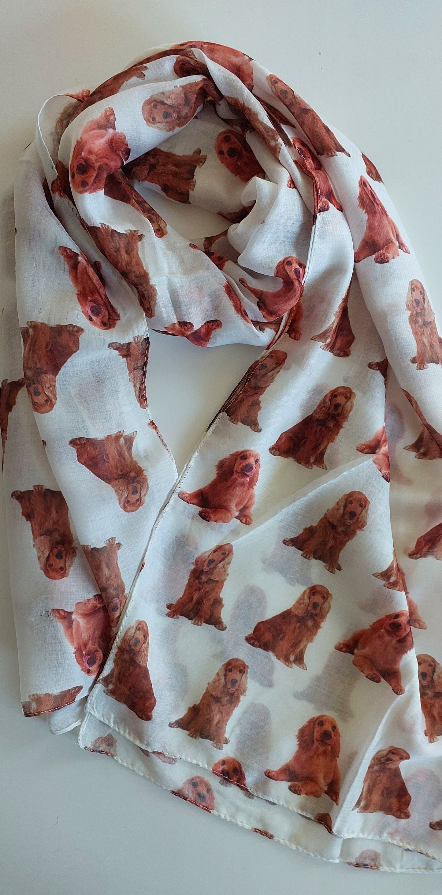 White Shimena scarf with tan cocker spaniels all over it, laid flat on a white background