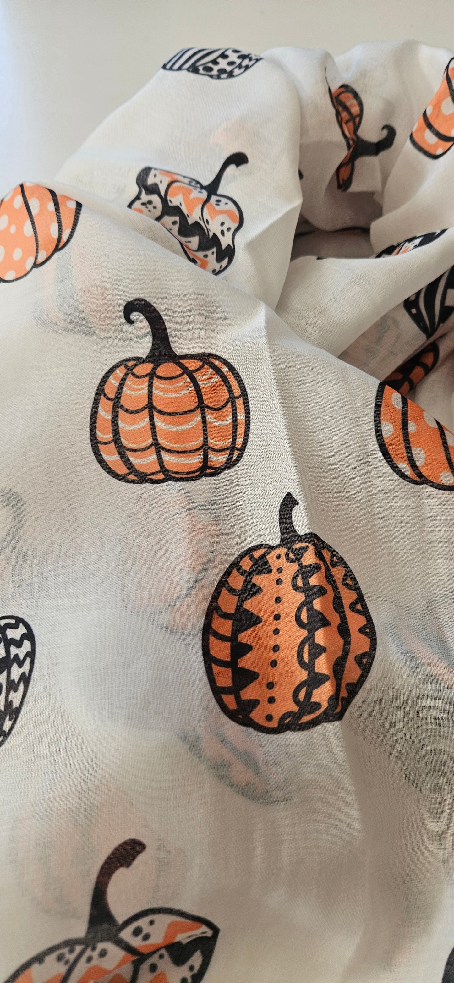 White Scarf with Halloween-themed pumpkins pattern on a white background