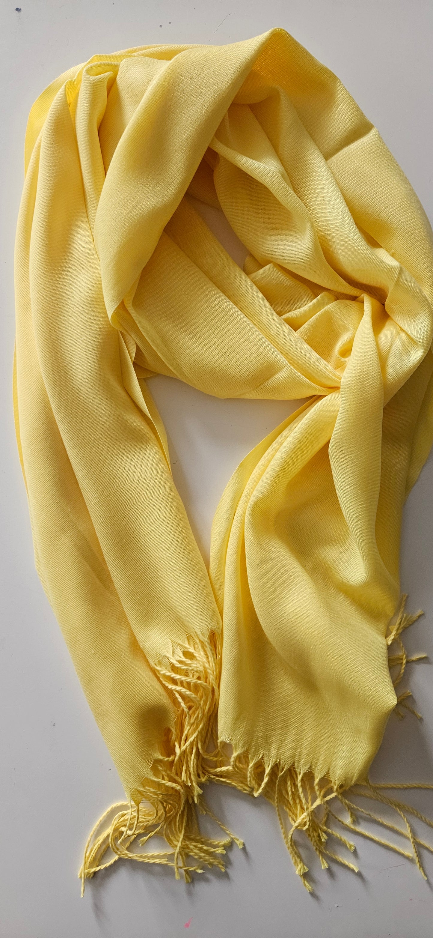 Yellow scarf with tassels on a white background
