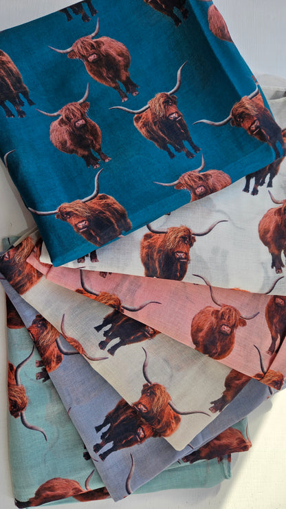 Collection of scarves with highland Cow pattern on a white background