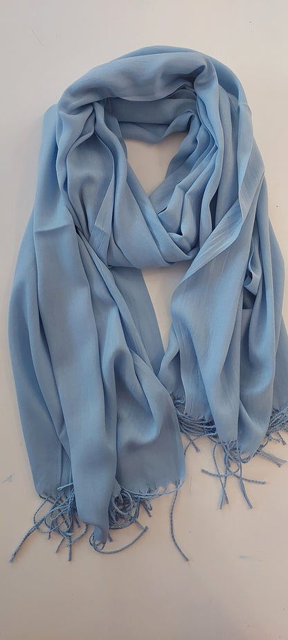 Light blue scarf with fringes on a white background