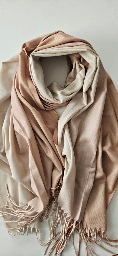 Beige two-toned scarf with tassels on a light background
