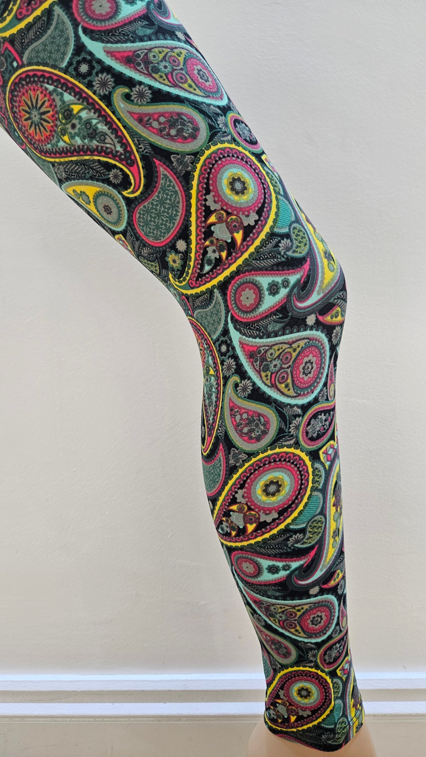 Colourful paisley-patterned leggings on a white background