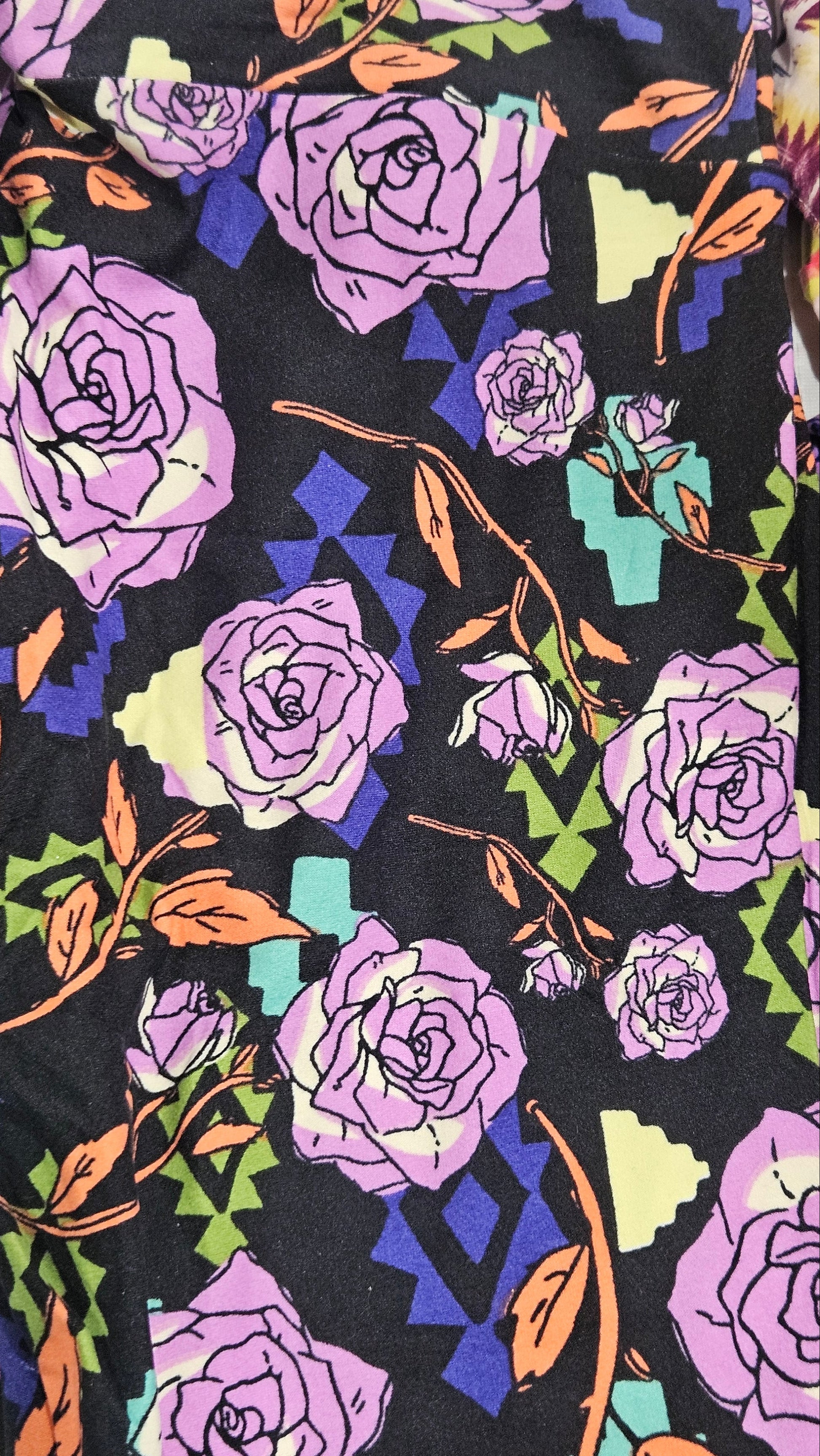Floral pattern with purple roses and green leaves on a black background