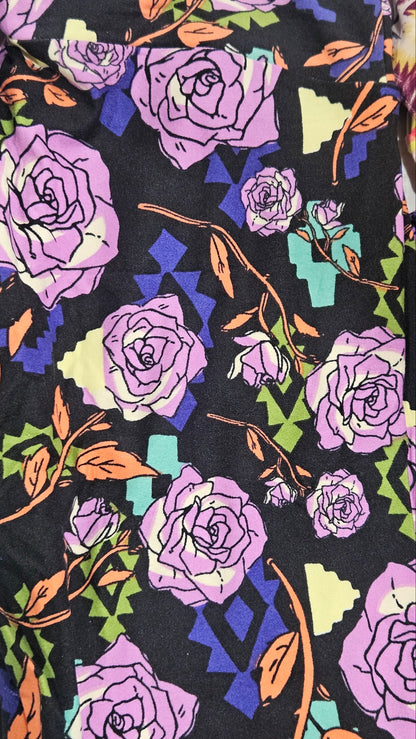 Floral pattern with purple roses and green leaves on a black background