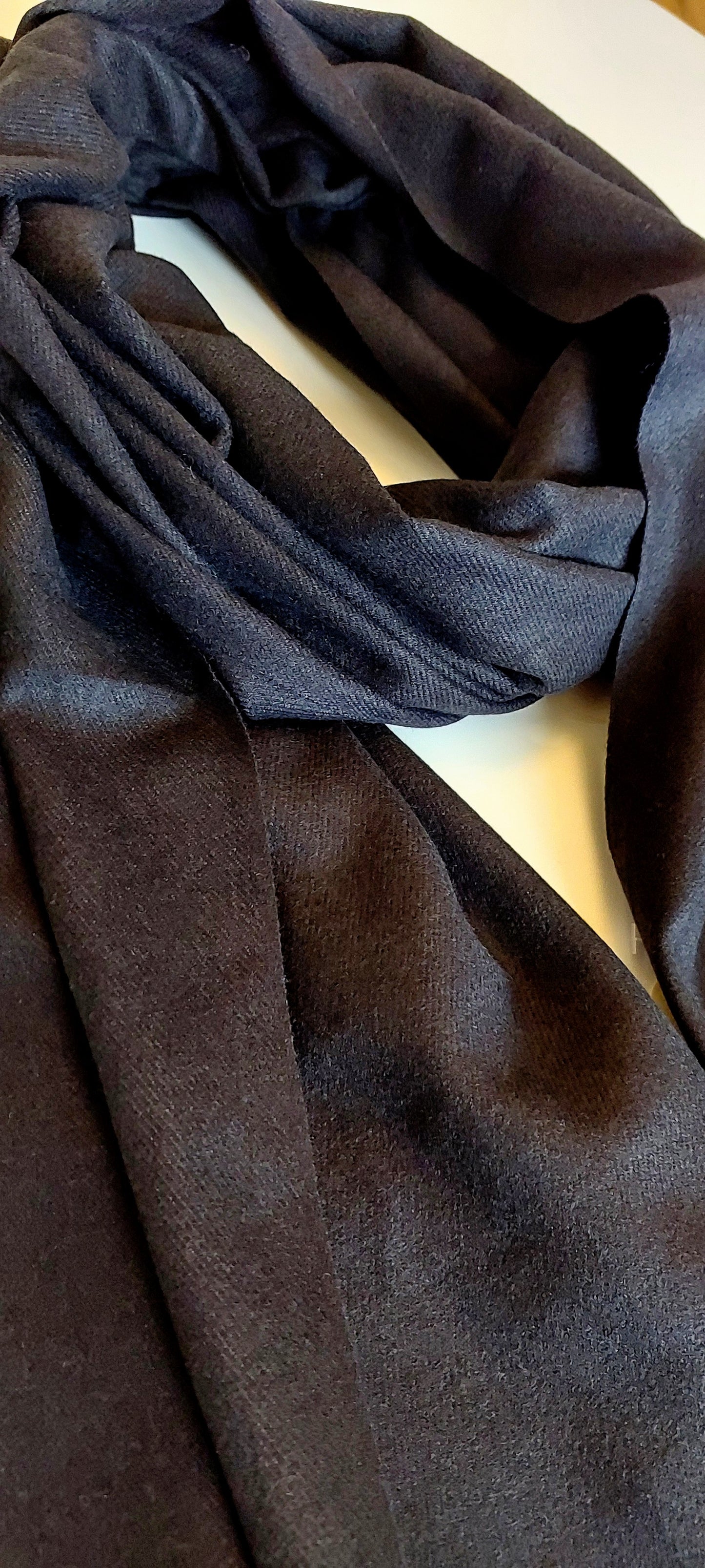 Close-up of a black pashmina on a white background