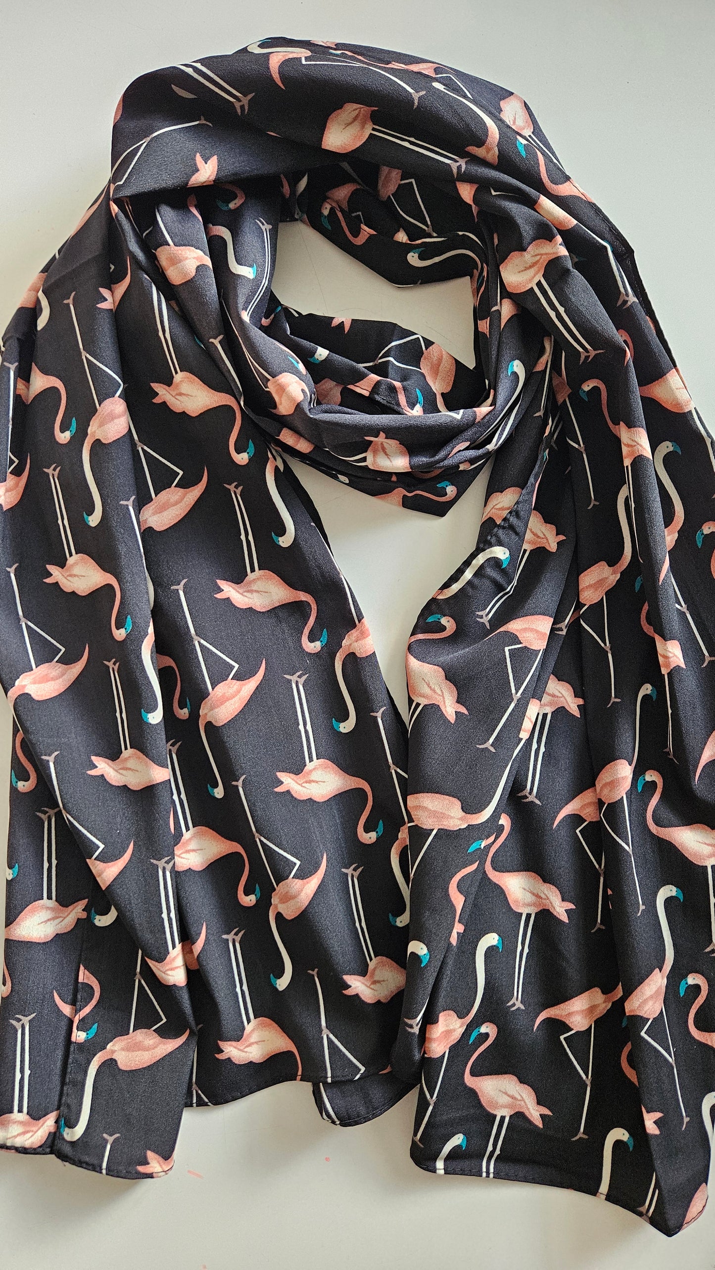 Black scarf with flamingo pattern on a white background