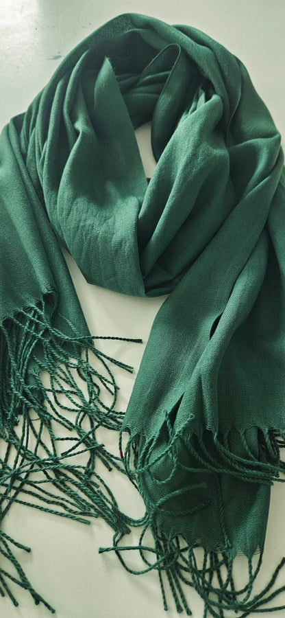 Green scarf with tassels on a white background
