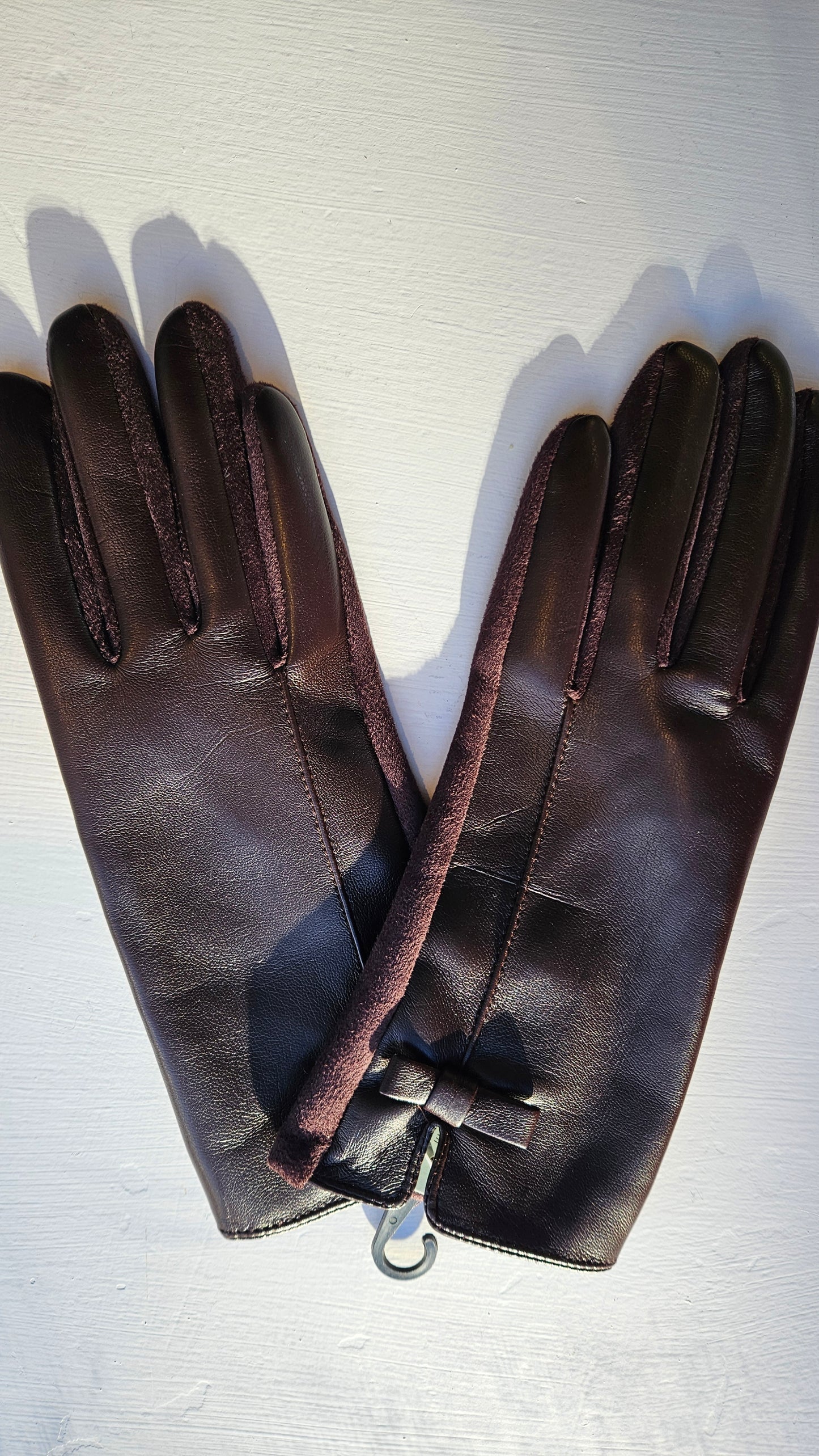 Brown Leatherette Gloves laid flat on a white background