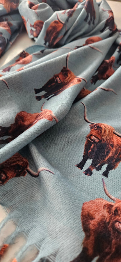 Scarf with brown highland cow print on a light green background