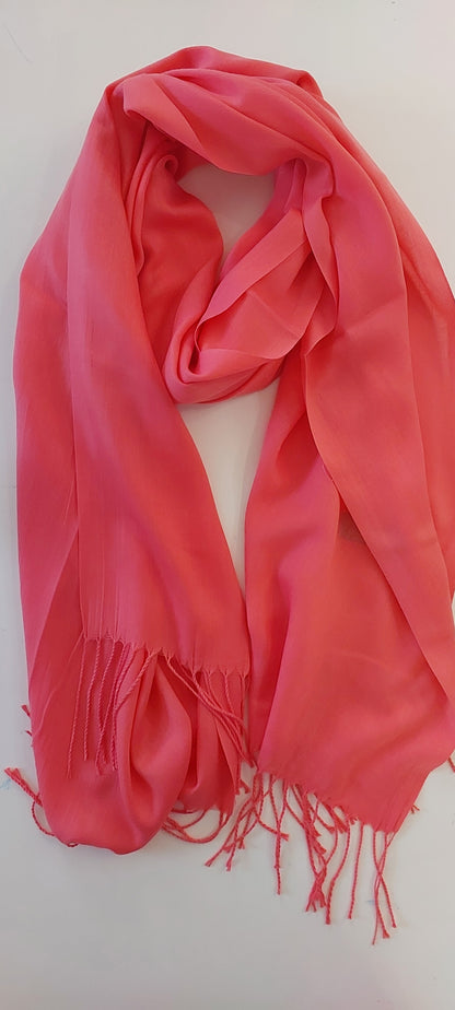 Coral Pink scarf with fringes on a white background