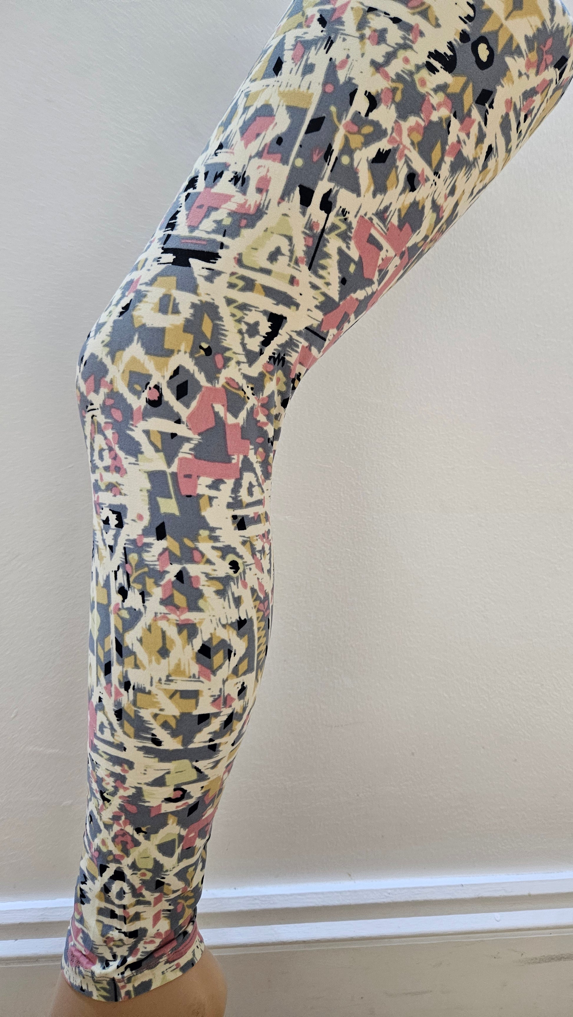 Patterned leggings against a plain background