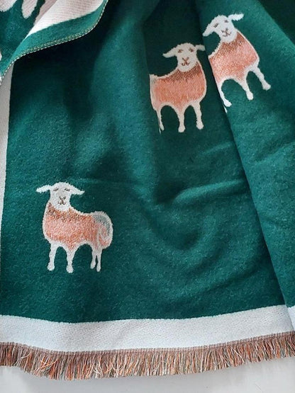 Green scarf with sheep designs on a white background 