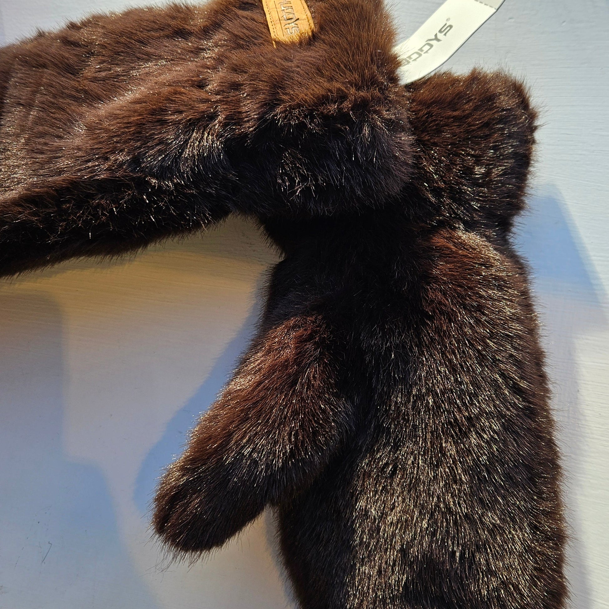 Brown faux fur mitterns on a white background