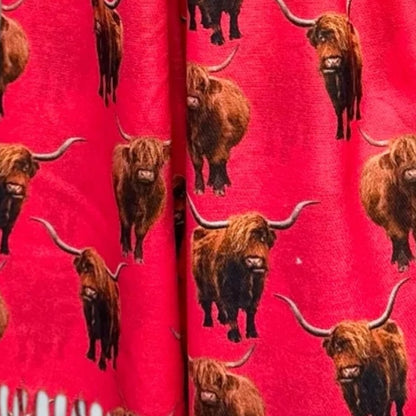 Fuchsia scarf material with full colour highland cows printed all over it