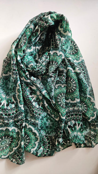 Green mandala patterned scarf with silver glittery dots on a white background