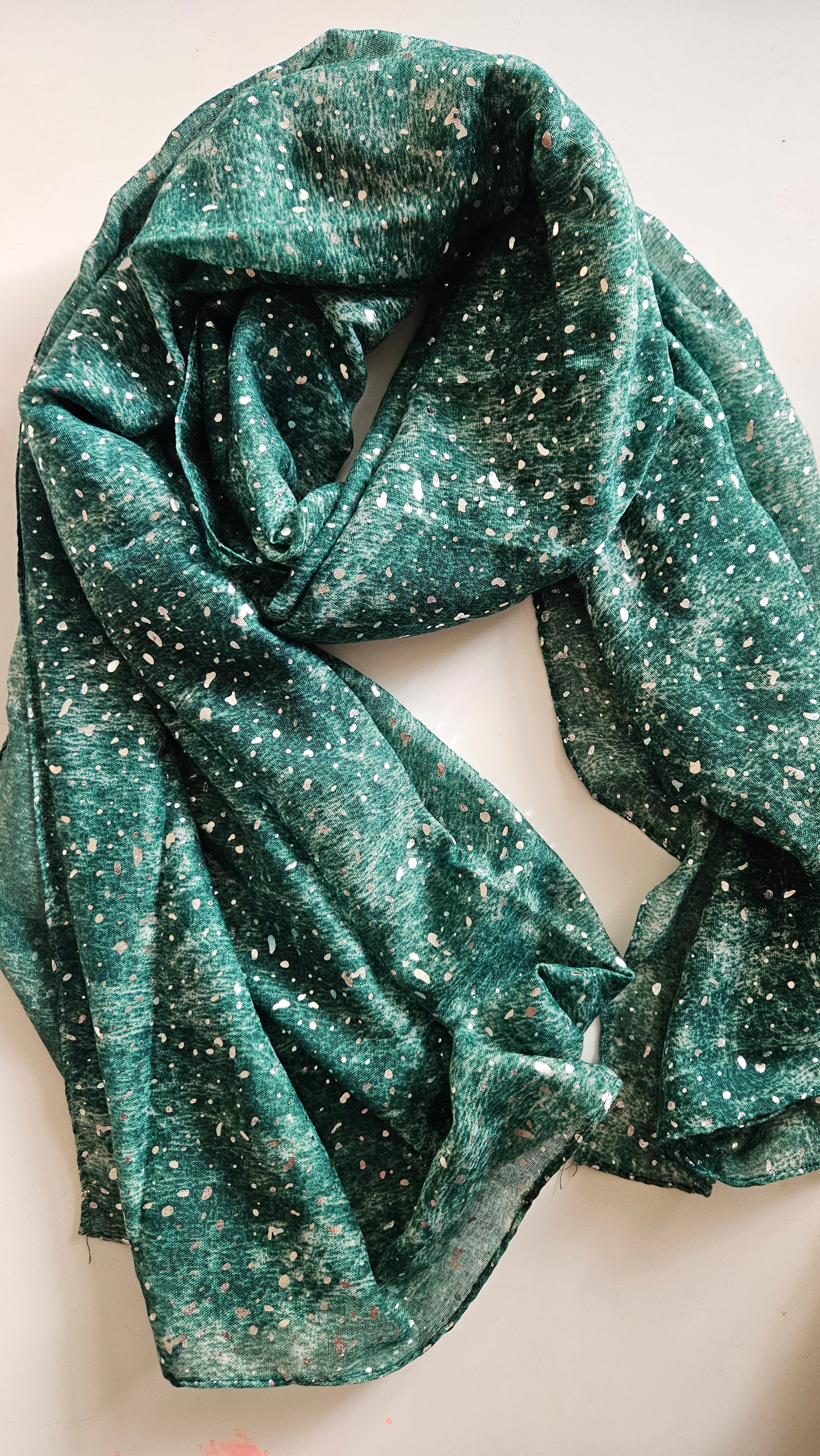 Green glittery scarf on a white background