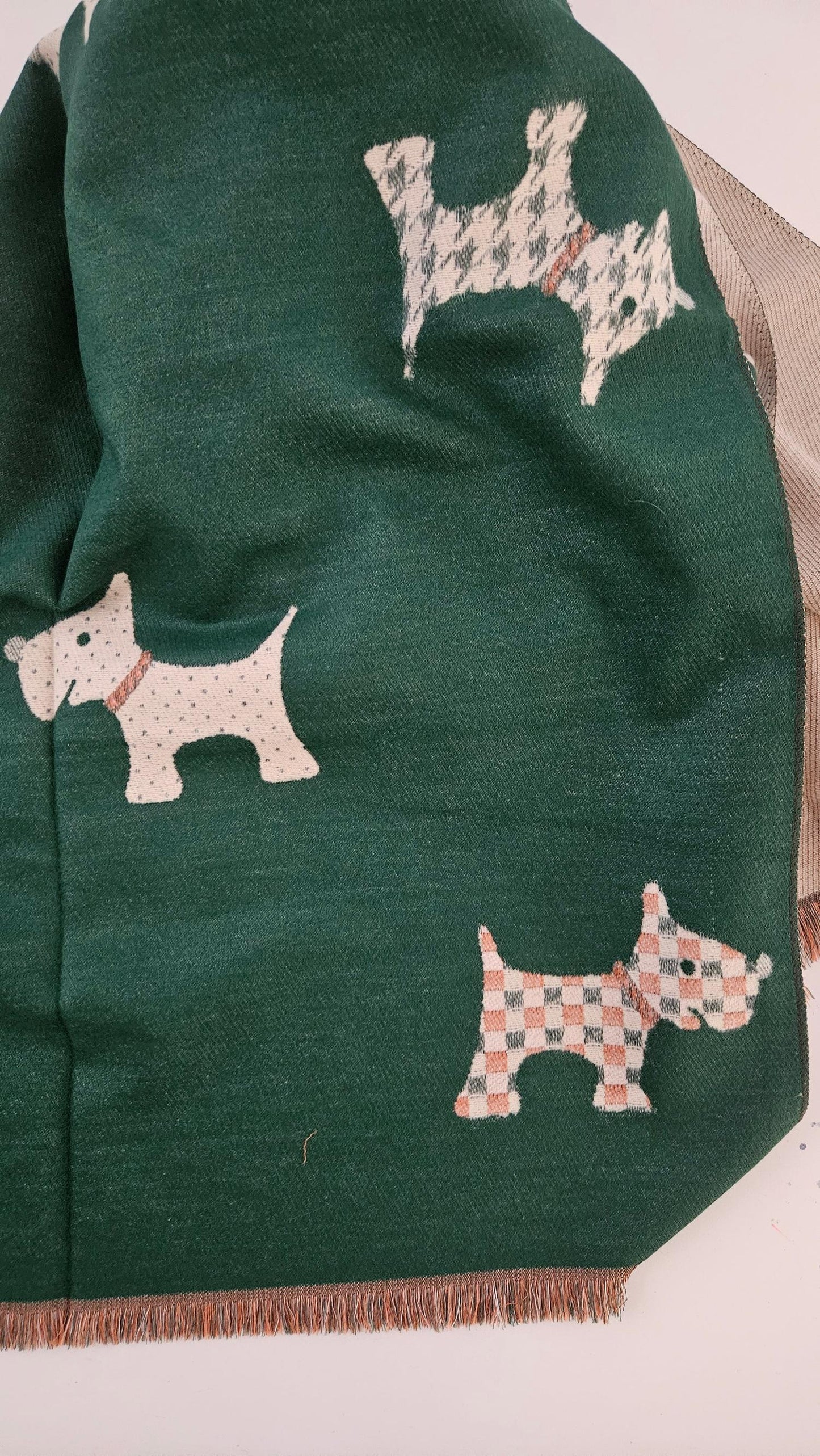 Green scarf with embroidered dog patterns on a white background