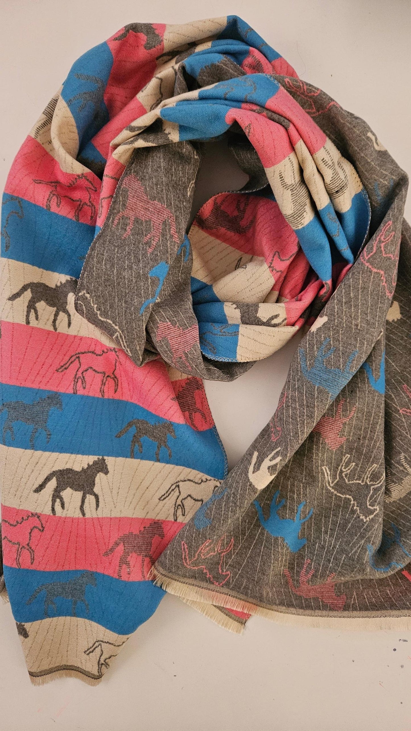 Multicolored pashmina with horse patterns on a white background