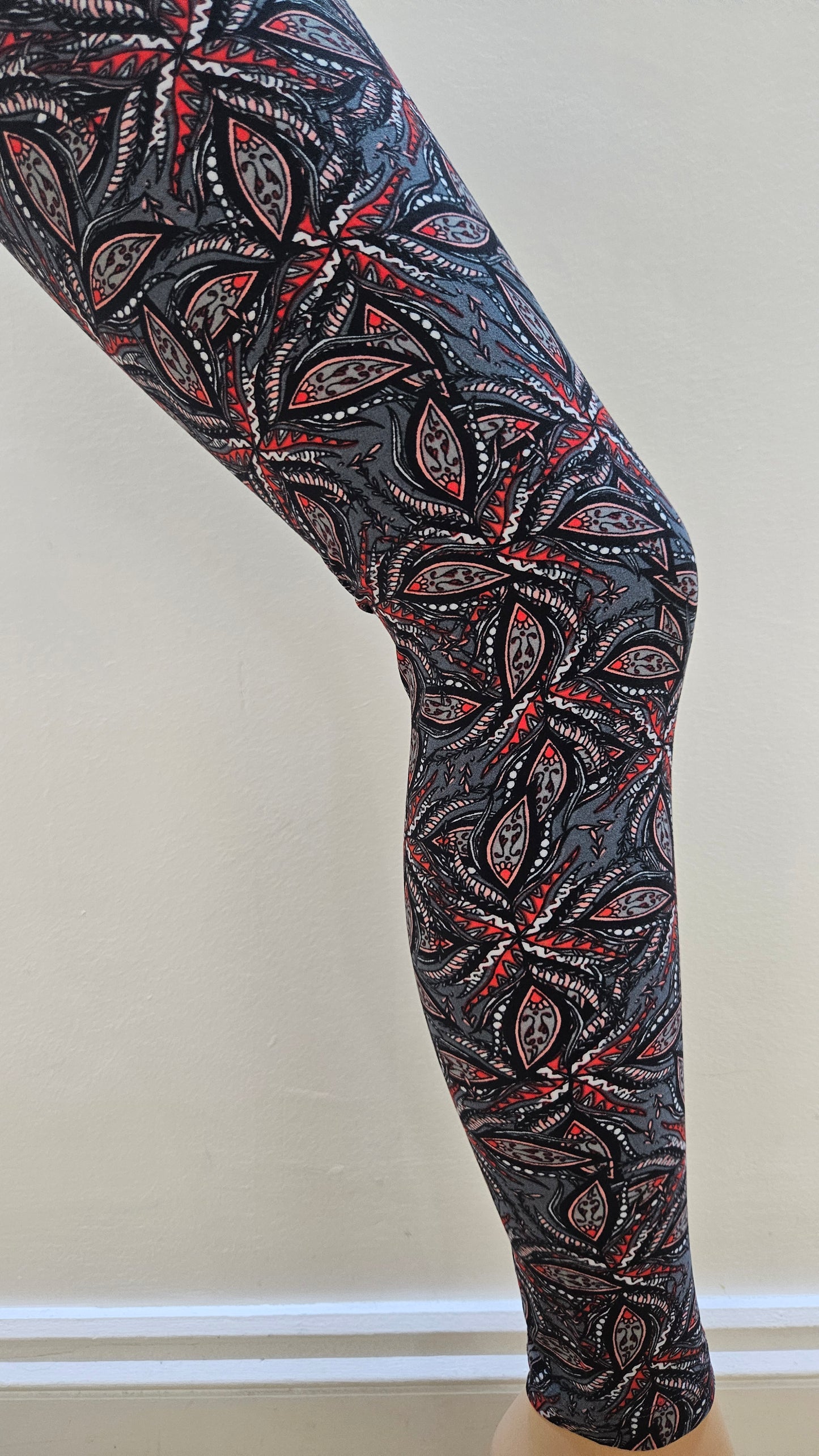 Decorative leggings with intricate paisley pattern on a plain background