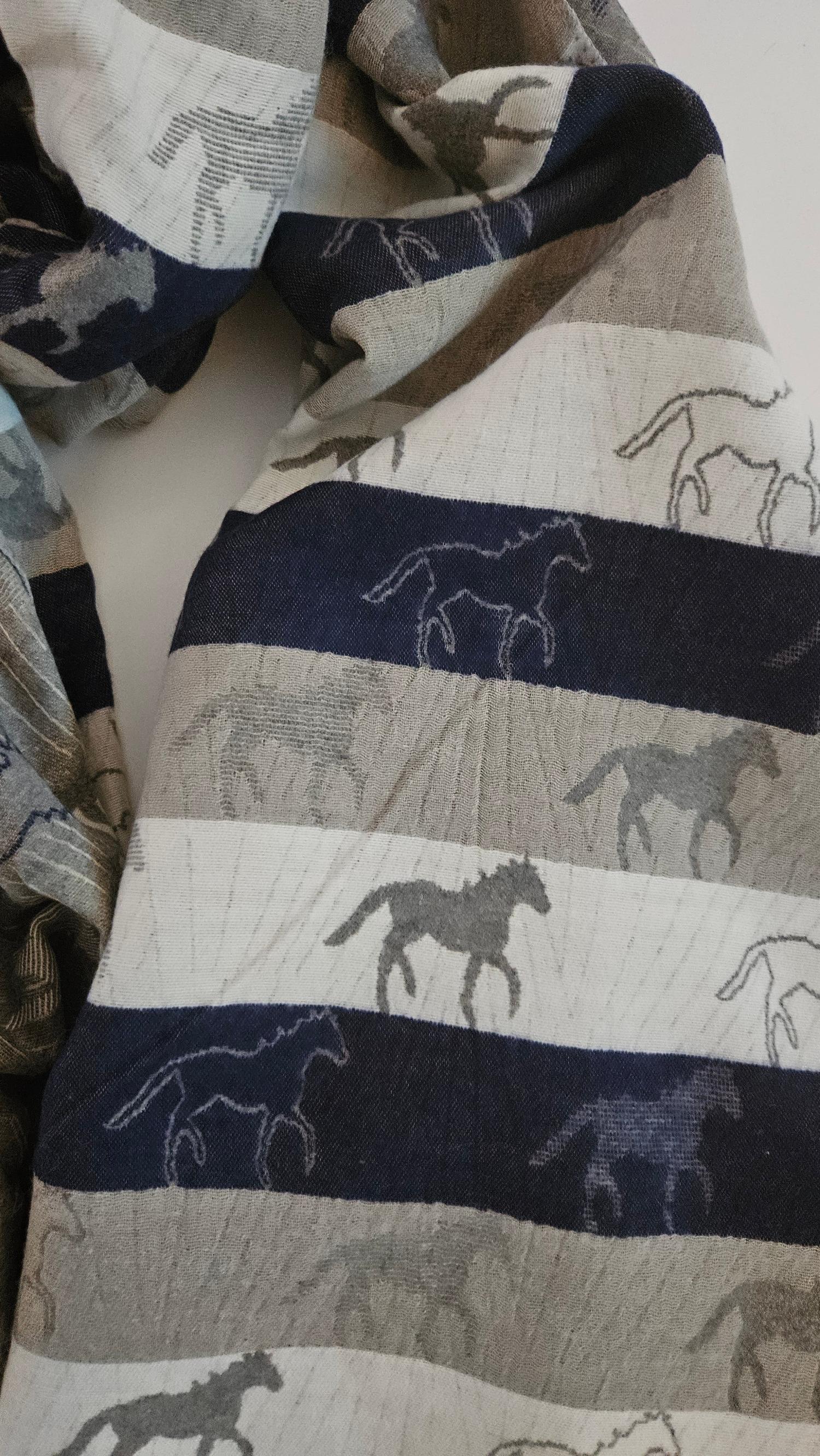 Scarf with horse patterns in various colours on a white background