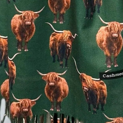 Bottle Green scarf fabric, with tassels showing at the bottom, with full coloured Highland Cows printed all over it
