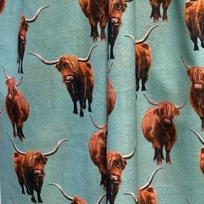 Mint green coloured scarf fabric with full colour Highland Cows printed all over it