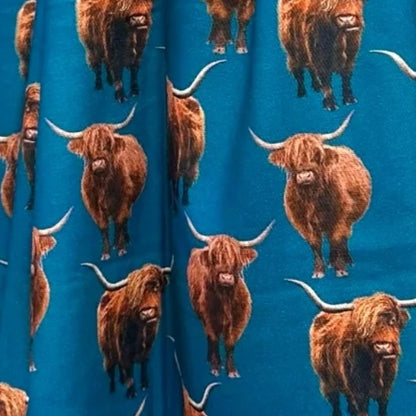 Electric Blue scarf material with full colour Highland cows printed all over it