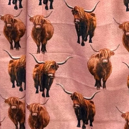 Pink coloured scarf with full colour Highland Cows printed all over it